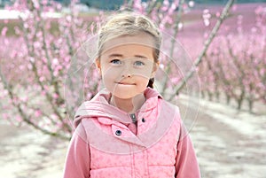 Lovely little girl in a grove of fruit trees in Cieza in the Murcia region. Peach, plum and nectarine trees. Spain