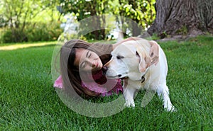 Lovely little girl with her best dog friend at park during summer in Michigan