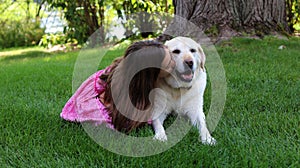 Lovely little girl with her best dog friend at park during summer in Michigan