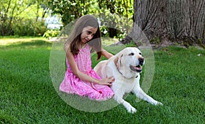 Lovely little girl with her best dog friend at park during summer in Michigan