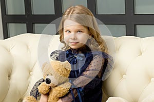 Lovely little girl hugging her teddy bear toy