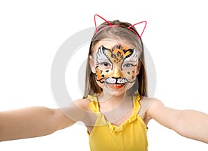 Lovely little girl with painted face making selfie