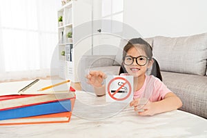 Lovely little girl presenting no smoking notice.