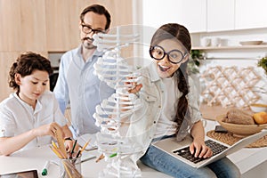 Lovely little girl studying biology in the kitchen