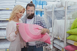 Lovely mature couple buying new pillows