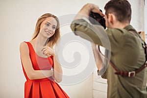 Lovely model poses for a photographer at a studio