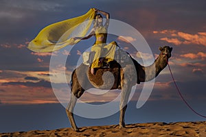 A Lovely Model Rides A Dromedary Camel Through The Saharan Desert On Their Camels In Morocco