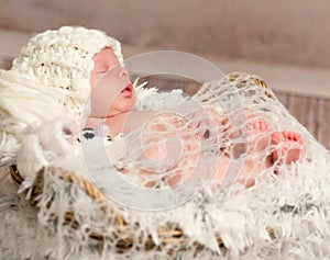 Lovely newborn baby in knitted white hat