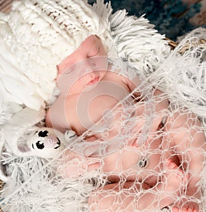 Lovely newborn baby in knitted white hat