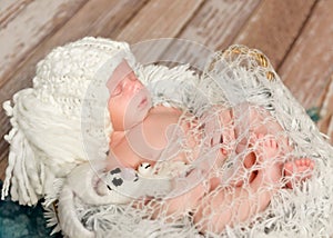 Lovely newborn baby in knitted white hat