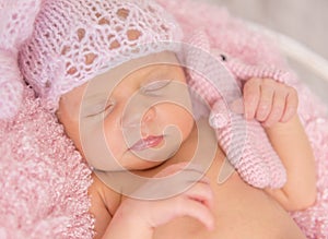 Lovely newborn girl in pink panties and hat in basket