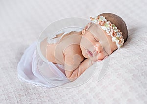 Lovely newborn girl sleeping on her stomach