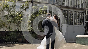 Lovely newlyweds caucasian bride groom dancing in park, making kiss, wedding couple family