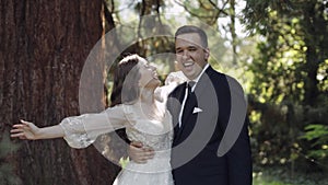 Lovely newlyweds caucasian bride groom dancing in park, making kiss, wedding couple family