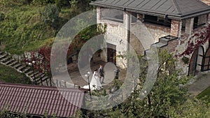 Lovely newlyweds caucasian bride groom walking in park, holding hands, wedding couple family