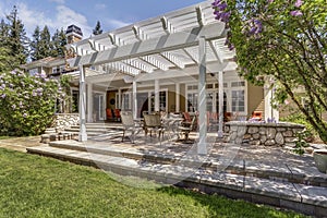 Lovely outdoor deck patio space with white dining pergola.