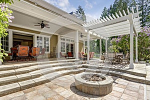 Lovely outdoor deck patio space with white dining pergola. photo