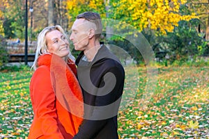 Lovely pair having fun in colorful autumn park
