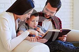 Lovely parents share special time with child while reading an in