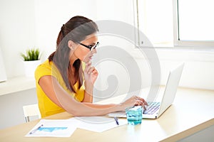 Lovely pensive secretary sitting in her workplace