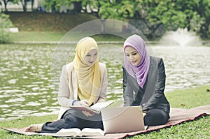 Lovely pleasant mix ethnic woman sitting on grass