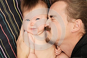 Lovely portrait of father and his little daughter. Happy fatherhood. Young dad with beard and little baby girl