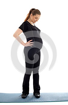 Lovely pregnant woman in black working out