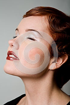 Lovely red-head young woman with closed eyes