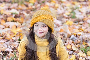 Lovely season. Keep warmest this autumn. Child in yellow hat outdoors. Autumn skin care routine. Kid wear warm knitted