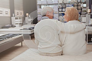 Lovely senior couple shopping at furniture store