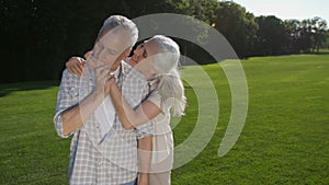 Lovely senior woman whispering husband about love