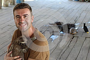 Lovely sloth hugging a man