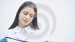 Lovely smiling female putting stethoscope over her neck, folding hands, looking confident, smiling.