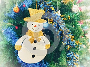 Lovely snowman, Christmas ornaments on Christmas tree.
