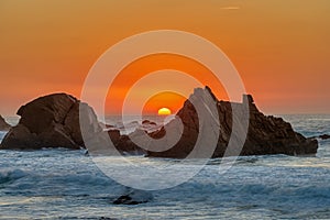 Lovely sunset on a rocky beach