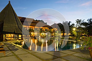 Lovely Sunset View at Pool Area with Nipa Hut Sunshade in a Tropical Beach Resort