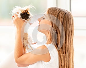 Young teen girl holding guinea pig on the floor