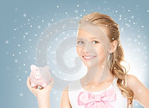 Lovely teenage girl with piggy bank