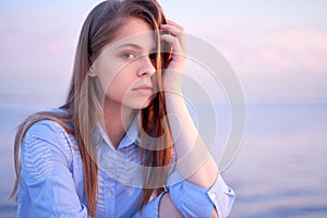 Lovely teenage girl with pleasant pensive look.