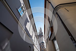 Lovely tight street in the old town. The church tower in the background. Bielsko-Biala, Poland. Saint Nicholas Cathedral