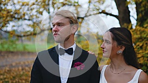 Lovely Turkish bride in her late 20s leaning her head over the arm of her Scandinavian spouse. Blond bearded handsome
