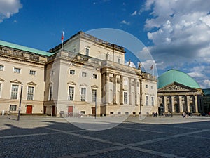 Lovely view of the Berlin State Opera building with the St. Hedwig's Cathedral on a sunny day