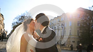 Lovely wedding couple kissing in the city shot in