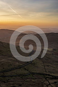 Lovely Winter landscape view from Red Screes across misty layers of mountains towards the East