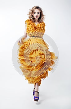 Lovely woman blonde fashion model in yellow dress