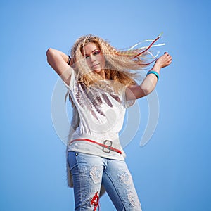 Lovely woman with a butterfly over blue sky.