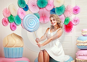 Lovely woman with huge marshmallow and cake sweets concept