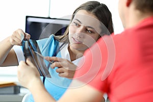 Lovely woman looking carefully at x-ray