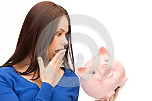 Lovely woman with piggy bank