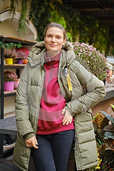 Lovely woman posing on autumn flower market